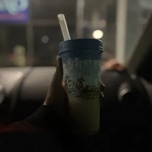 a person holding a drink in their hand