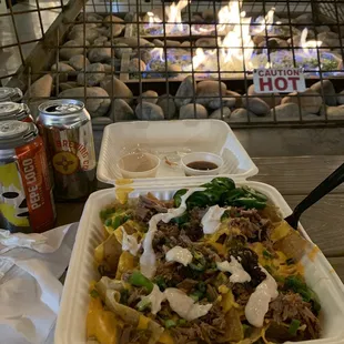 a container of food and a can of hot sauce