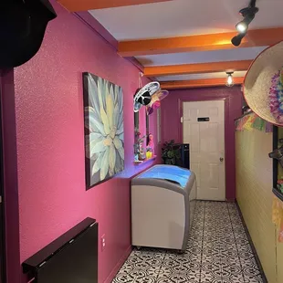 a room with a bed and a television