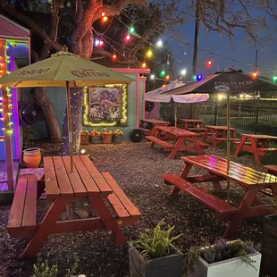 an outdoor area with picnic tables and umbrellas