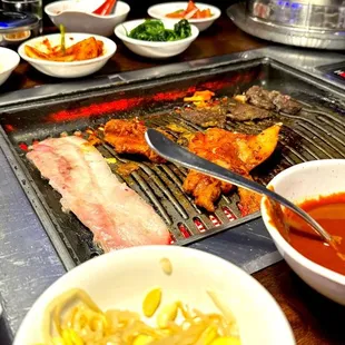 The grill in the center of the table. You can cook things fast and never feel hot while you're doing it. Great system!