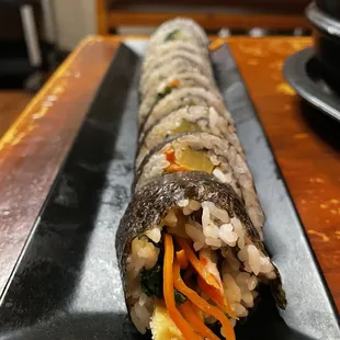 a sushi roll on a black plate