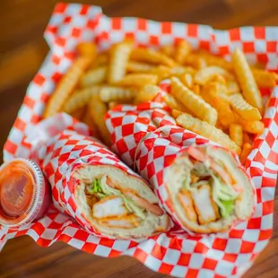 a basket of french fries and a sandwich