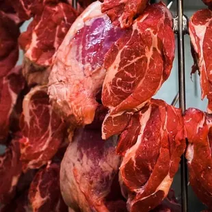 a bunch of meat hanging from a rack