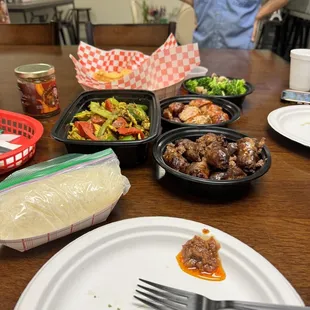 a table with plates of food and utensils