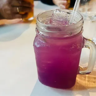 a purple drink in a mason jar