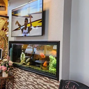 Tv and fish tank at front of restaurant