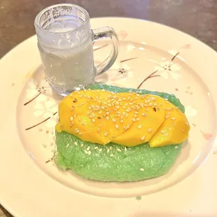 Fresh mango on warm sweet sticky rice with side of coconut cream