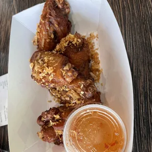 a plate of fried chicken wings with a dipping sauce