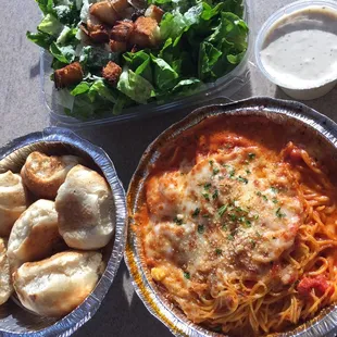 Dinner rolls, Cesar salad, and baked shrimp pasta! Loved it! Delivered a a fresh! Awesome food! Must try!