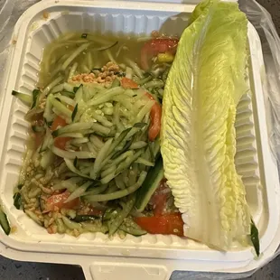 a salad in a styrofoam container