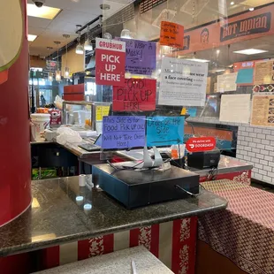 a restaurant counter with signs on it
