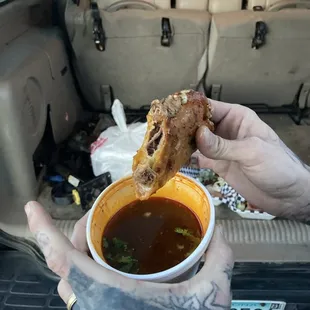 a person holding a bowl of soup