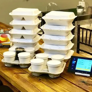 a stack of containers and a tablet