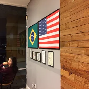 a woman sitting in a chair in front of an american flag