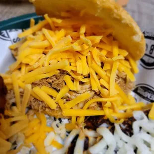 shredded cheese on a sandwich