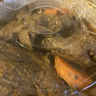 a pot of beef and carrots