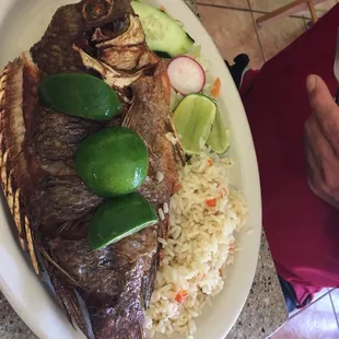 Fried tilapia. Rice and salad.