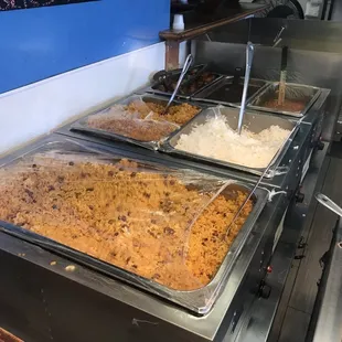three pans of food being prepared