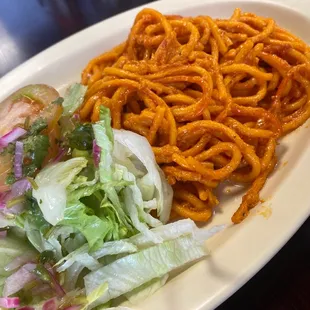 a plate of pasta and salad