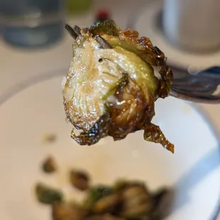 a fork lifting up a piece of broccoli