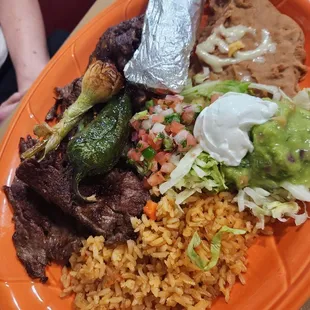 Carne Asada, seasoned steak with grilled onion and jalapeño, all the sides &amp; tortillas.