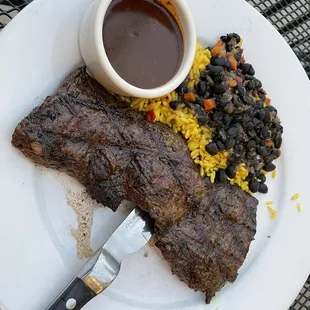 Churrasco steak with rice and beans and red wine mole sauce