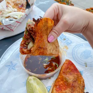 a hand holding a piece of food