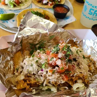 Salvador Fries, yuca fries with shredded chicken, cabbage, pico, cotija.