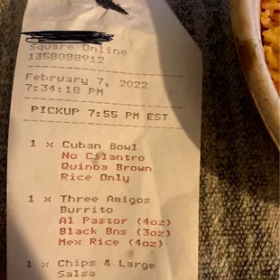 a receipt and a bowl of fries