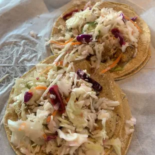 2 Curtido Fish Tacos, no cilantro or tomato. Not listed on the menu but there is also cotija or queso fresco on it
