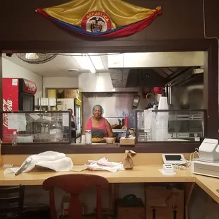 Small in the hole restaurant - two Colombians working behind the kitchen