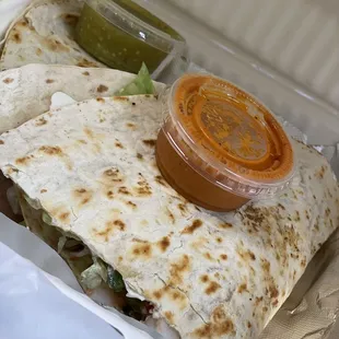 a burrito in a styrofoam container