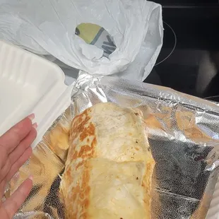 A chorizo chicken burrito with rice the size of my face