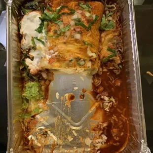 Half of the chicken burrito in a platter sized takeout container. Large portion! Could easily serve 3 people.