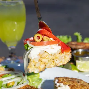 a person holding a fork over a plate of food