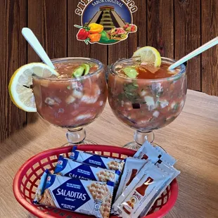 two glasses of soup and a bag of crackers