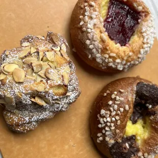 Almond croissant, raspberry pastry and a chocolate custard pastry