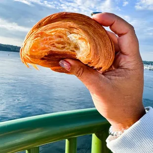 a person holding a croissant