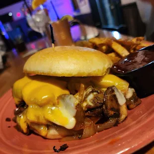 a burger and fries on a pink plate