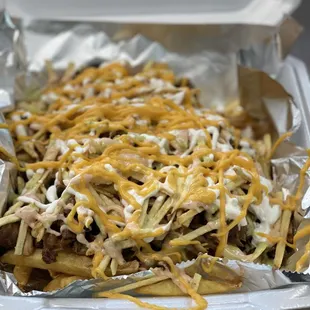 Loaded fries with pulled pork, steak and chicken