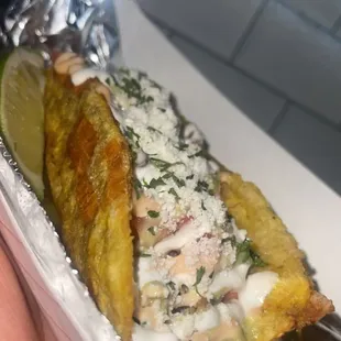 Plantain taco with choice of protein pico de gallo sour cream, house sauce.