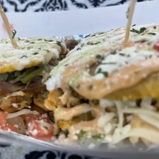 Plantain sandwich choice of protein lettuce tomatoes topped with house sauce and avocado cilantro sauce.