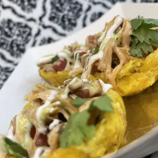 Plantain bowls choice of protein lettuce pico de gallo and topped with house sauce avocado sauce and sour cream.