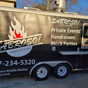 a woman standing in front of a food truck