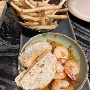 a bowl of shrimp and french fries