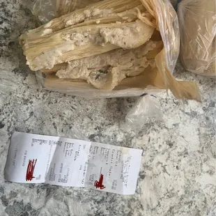 a receipt and a bag of tamales