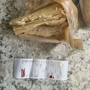 a receipt and a bag of tamales