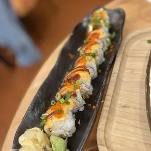 a sushi on a black plate