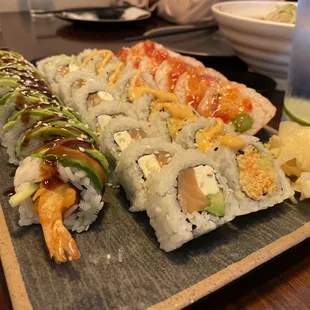 Four (4) types of sushi are shown. (L to R) Green Dragon, Philly (Philadelphia), Spicy California, and Boston rolls.